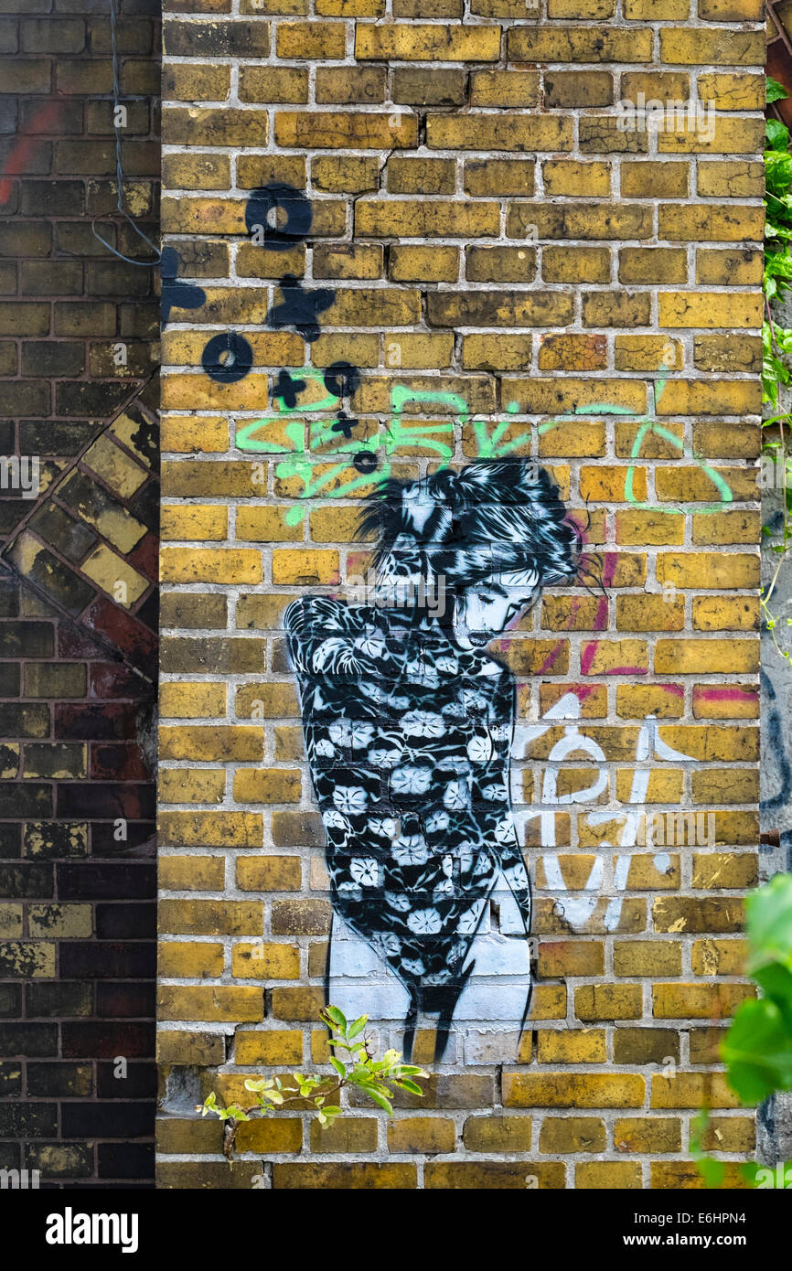 New stencilled street art of woman by artist XOOOOX in Berlin Germany Stock Photo