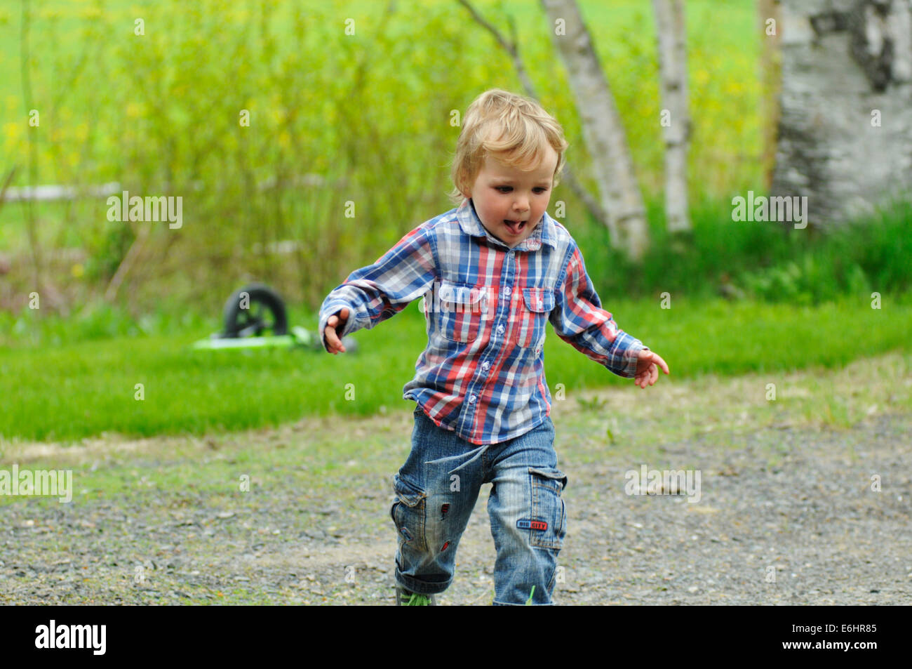 A two year old boy running Stock Photo Alamy