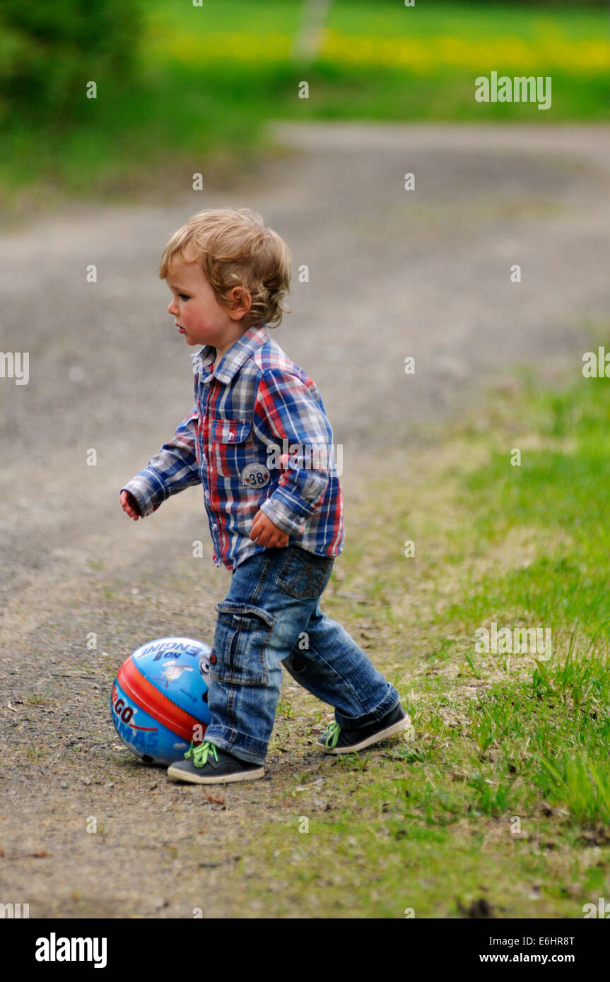 A young boy playing with a ball Stock Photo