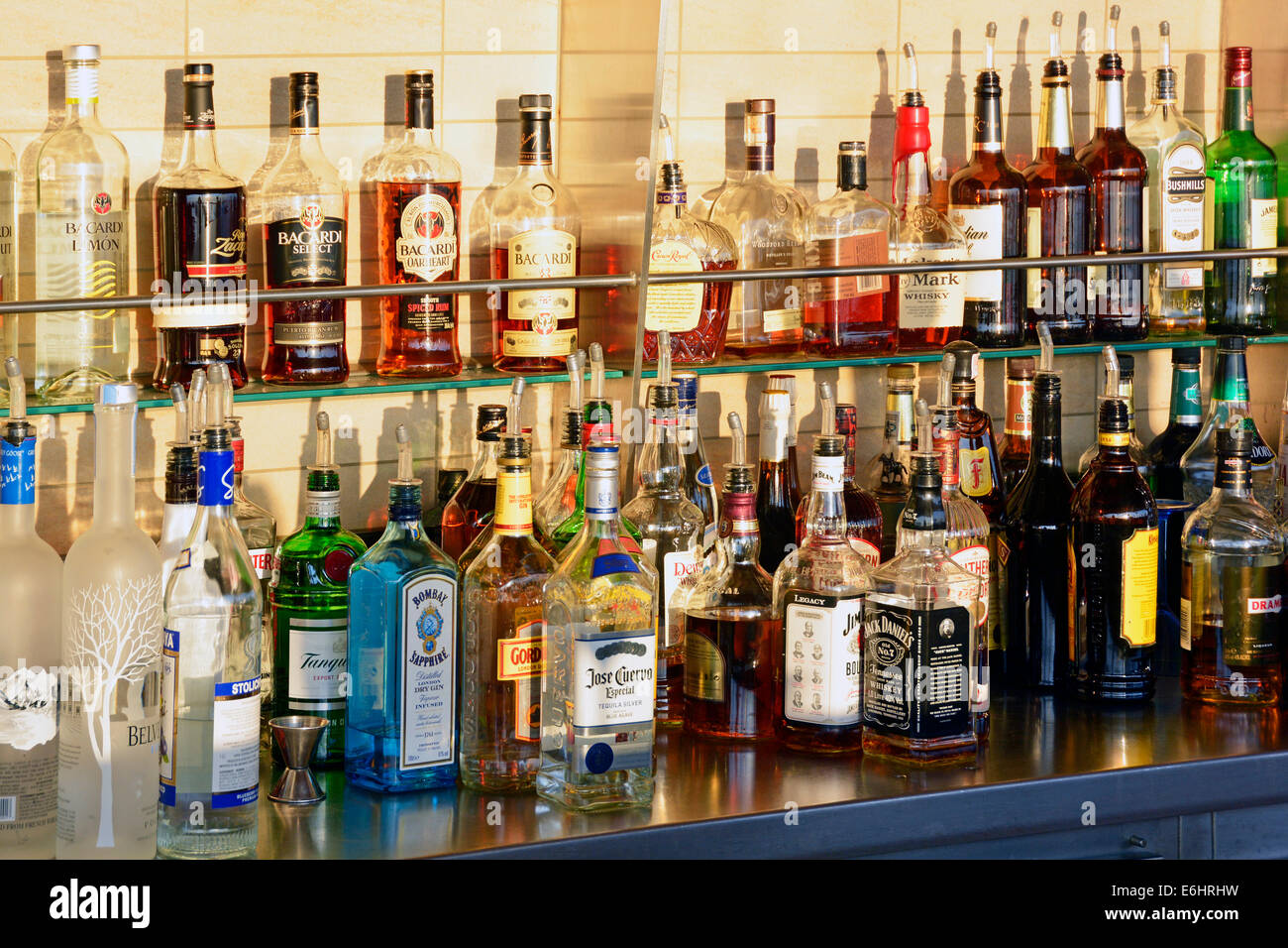 Cruise ship sun deck closeup of spirit drinks available behind outdoor bar counter including bottles of Gin, Bicardi & Whiskey Stock Photo