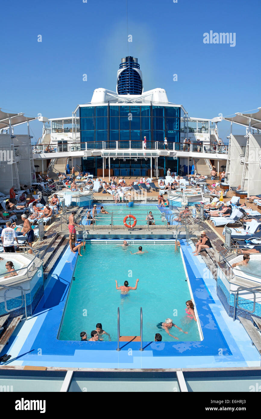 People in cruise ship liner swimming pools and Jacuzzi relaxing on the ...