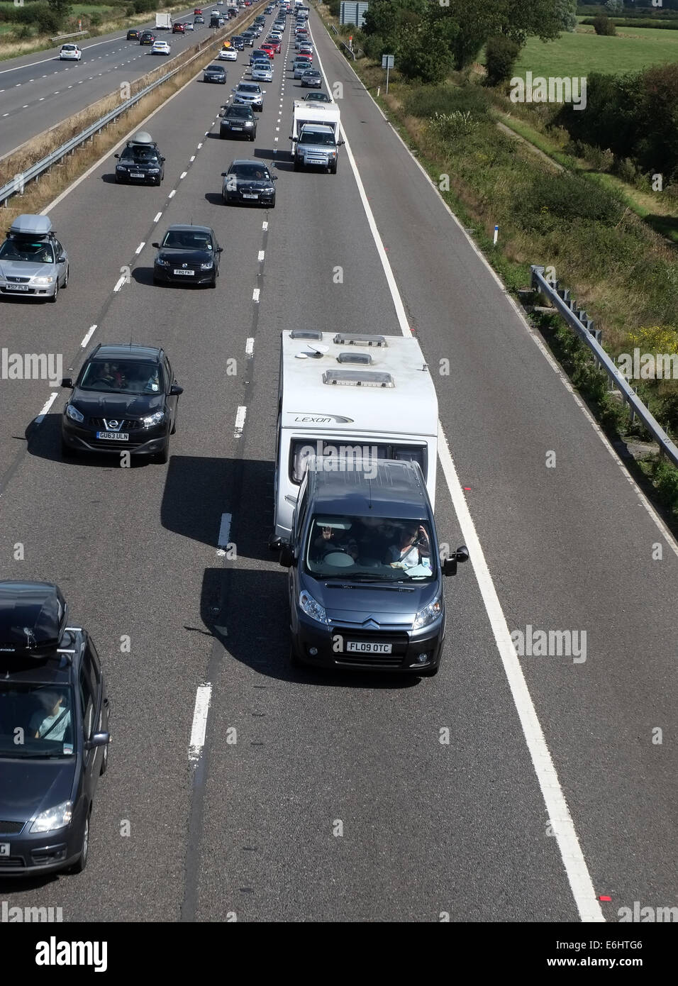 Busy bank holiday traffic on the M5 motorway heading down South West,  many caravans in the slow traffic. 23rd August 2015 Stock Photo