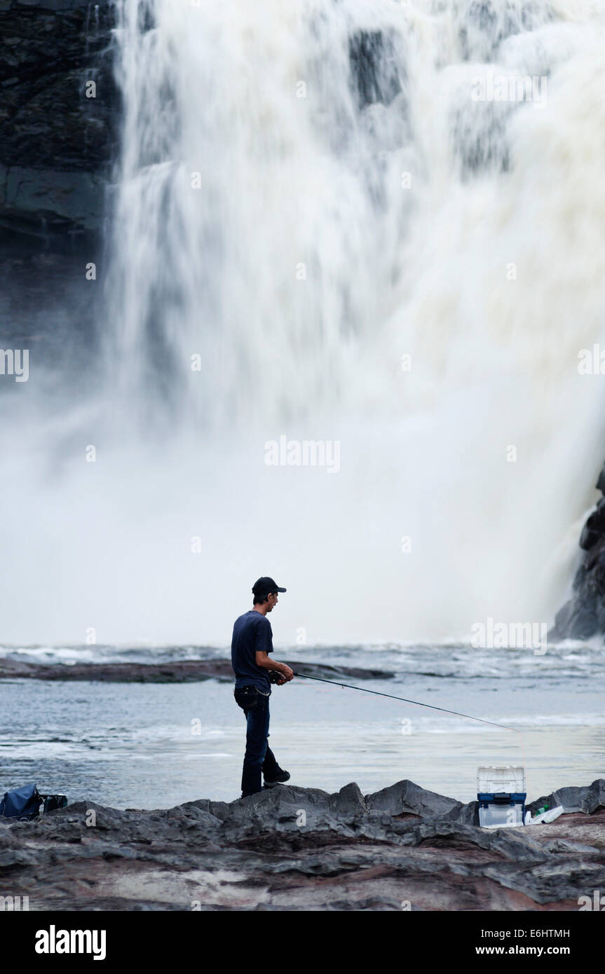 A man fishing at Chute de la Chaudiere waterfall near Quebec City Stock Photo