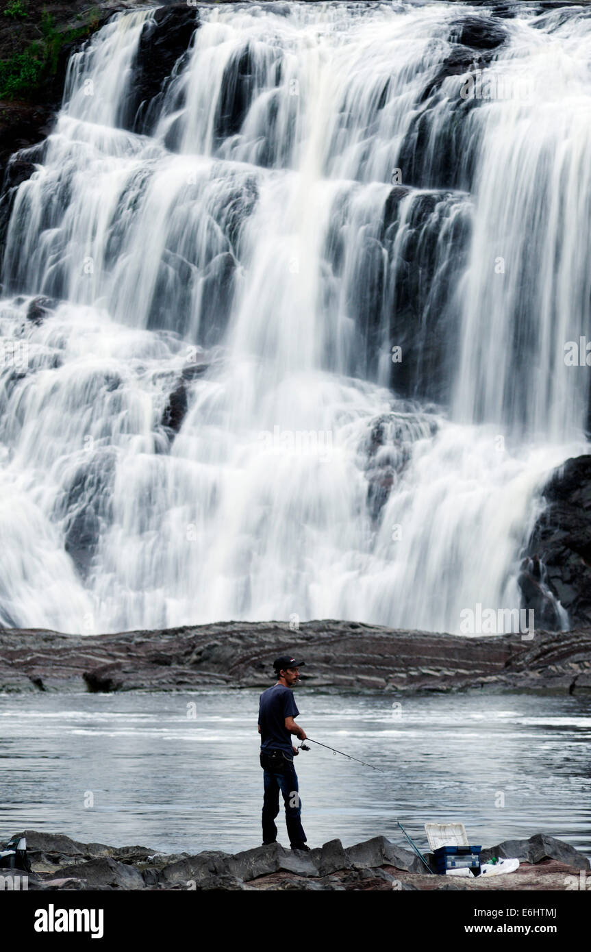 A man fishing at Chute de la Chaudiere waterfall near Quebec City Stock Photo