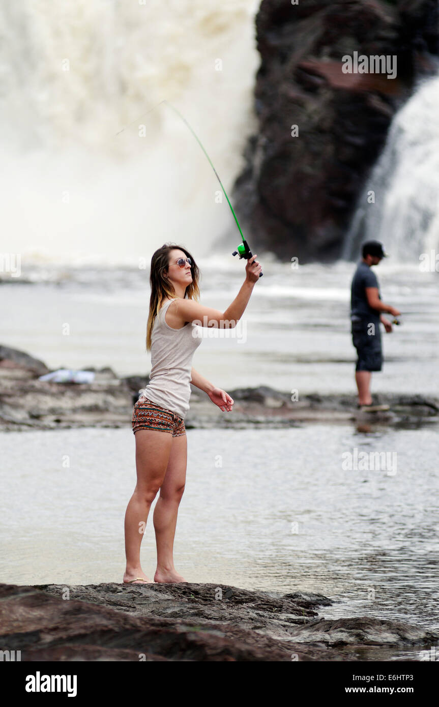 A young woman wild fishing in Quebec Canada Stock Photo