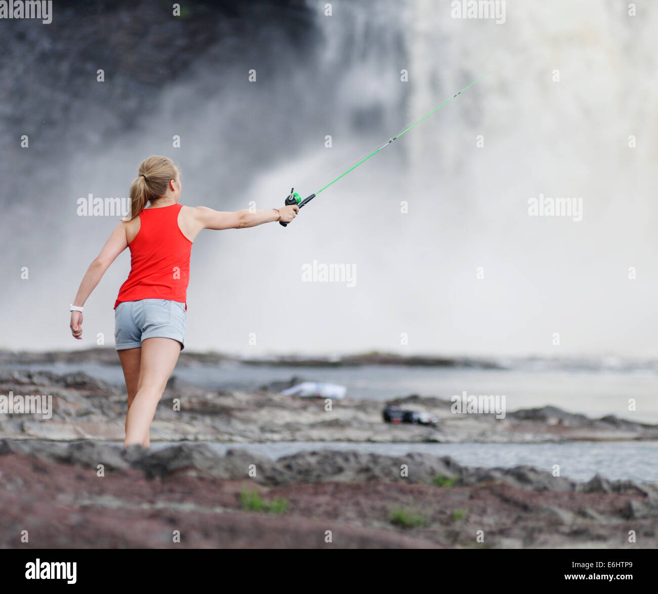 A young woman wild fishing in Quebec Canada Stock Photo Alamy