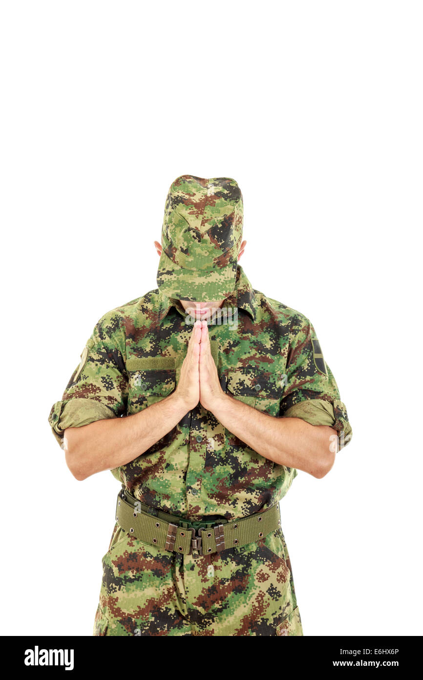 Marine soldier combatant officer praying for peace in military uniform with head bowed Stock Photo