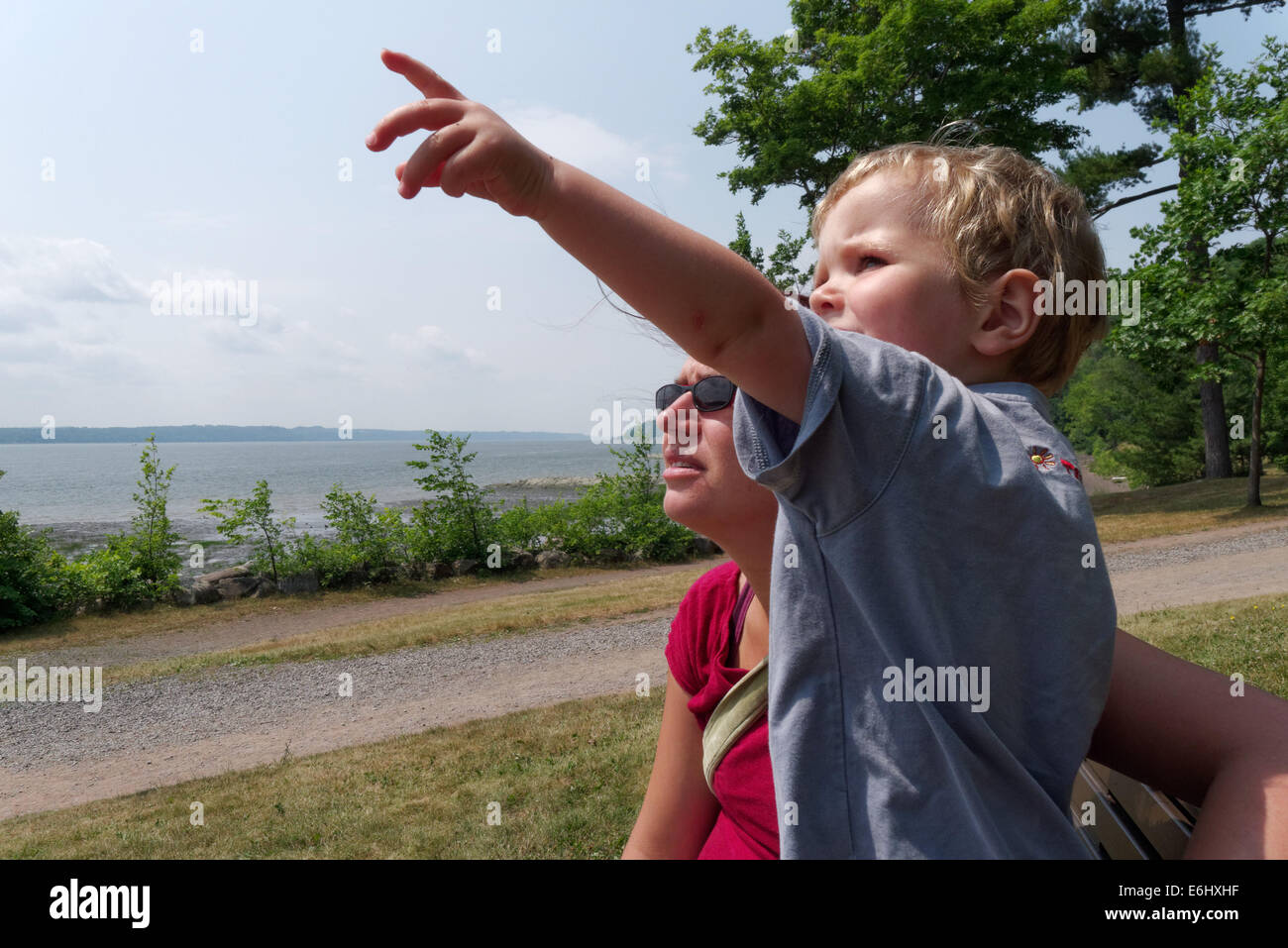 A two year old pointing something out to his mum, with the St Lawrence river at Quebec beyond Stock Photo