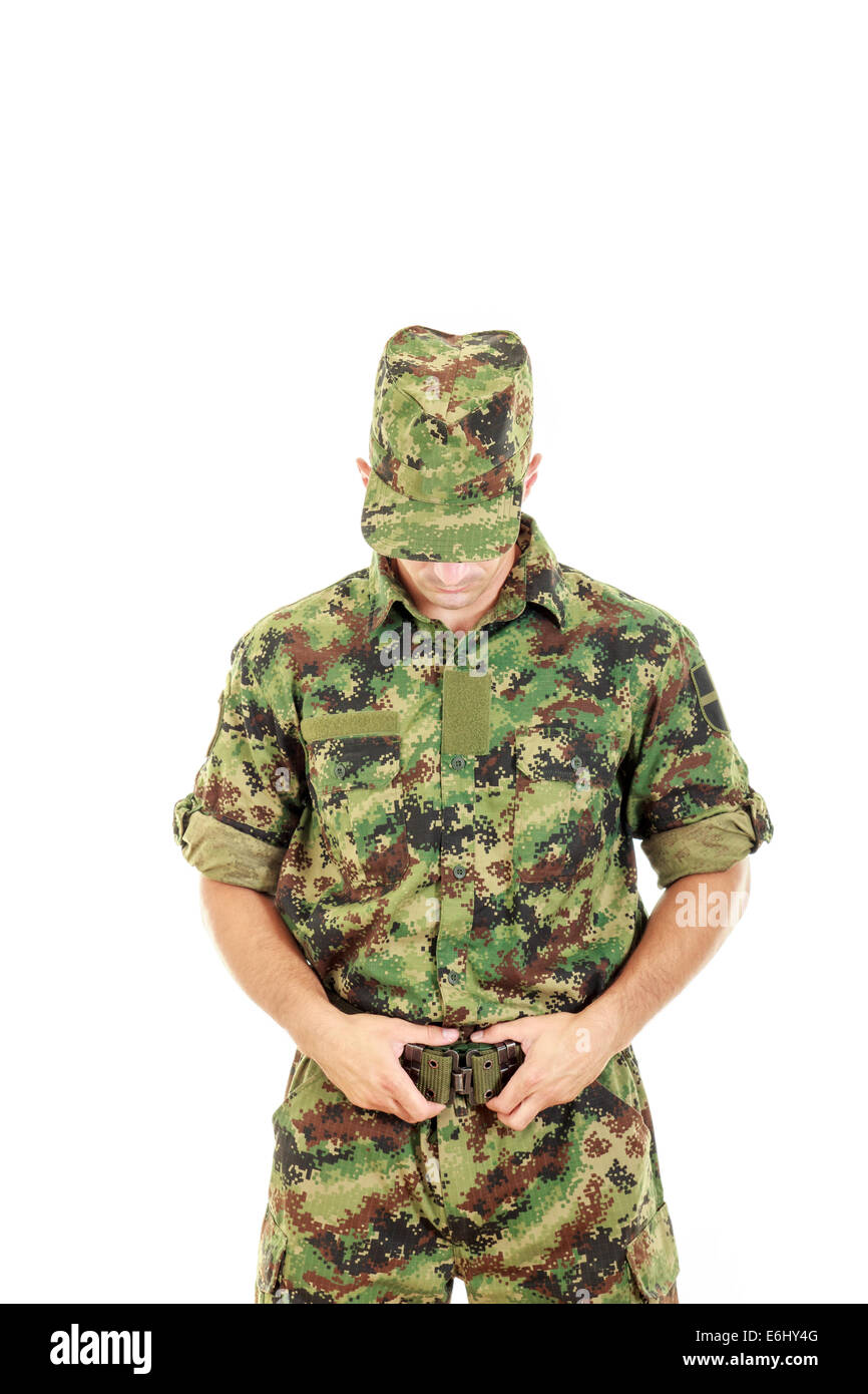 Army soldier warrior in military camouflage uniform fastened belt with head  bowed Stock Photo - Alamy