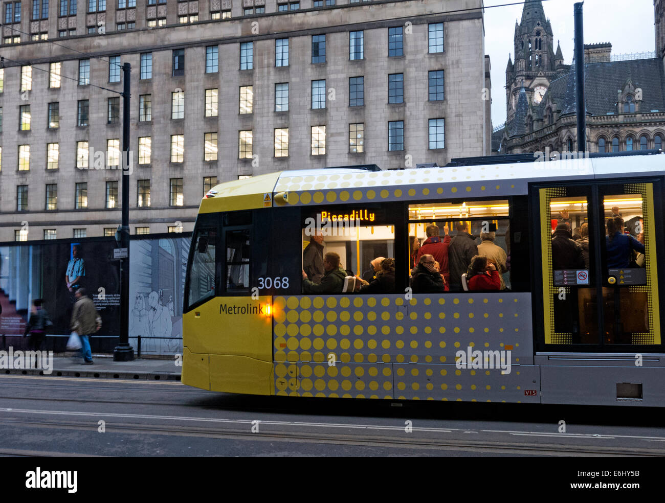 Yellow Manchester trams at dusk, England, UK Stock Photo