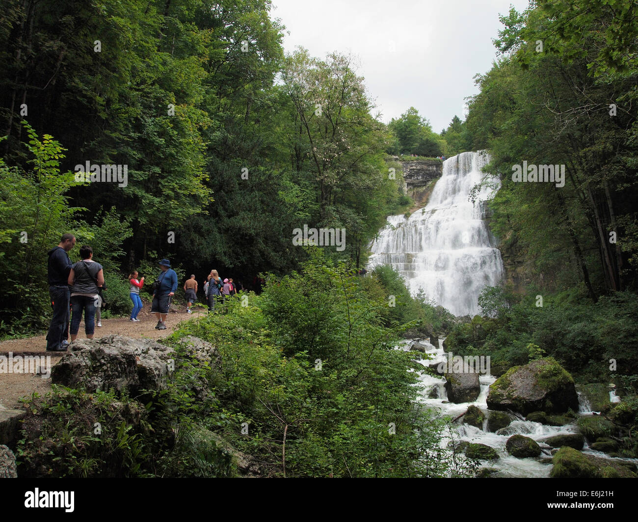Tourists visiting the large waterfalls at Cascades de Herisson in the Jura region in France Stock Photo