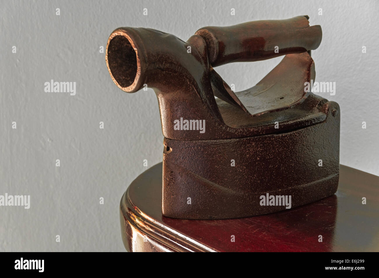 Old charcoal clothing iron on a wood board Stock Photo Alamy