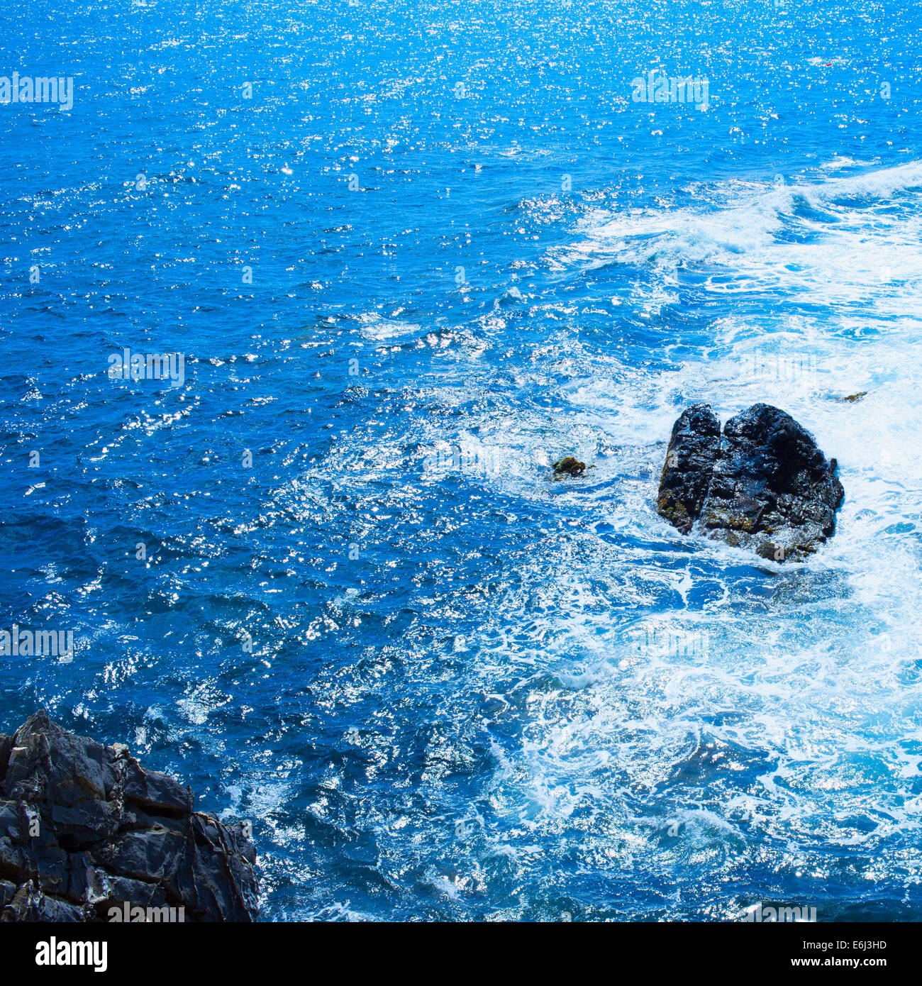 Rocks in the sea with foam, square image Stock Photo