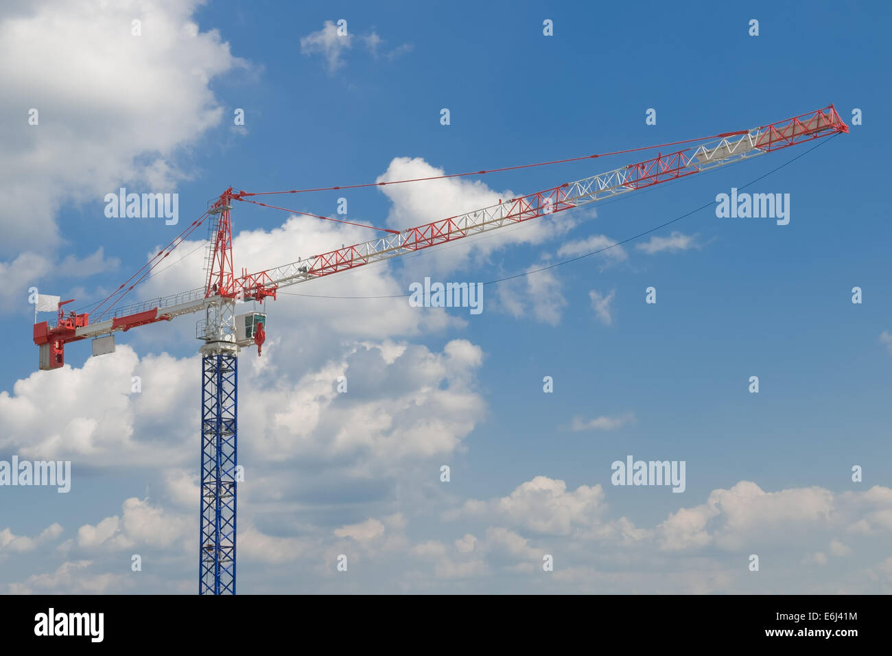 construction crane on blue cloudy sky background Stock Photo - Alamy