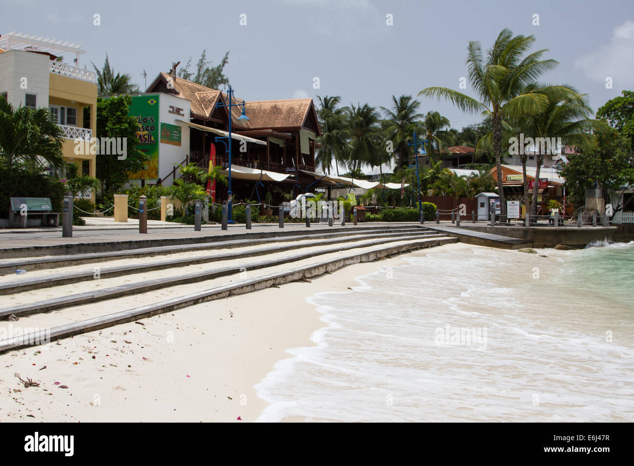 Street view of St Lawrence Gap 'The Gap' with boardwalk, sea, and beach Stock Photo