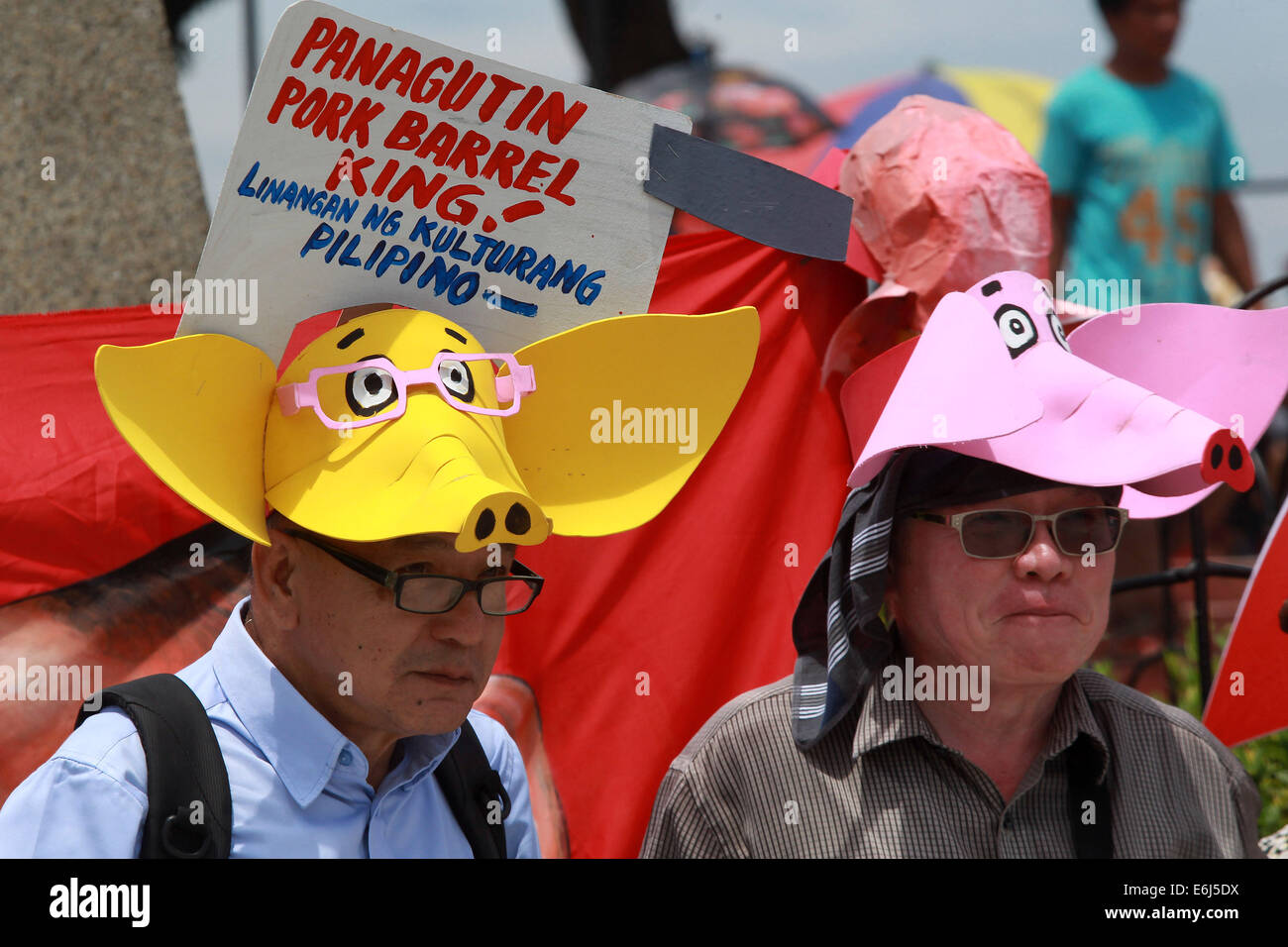 Manila, Philippines. 25th Aug, 2014. People wear pig hats during a protest rally in Manila, the Philippines on Aug. 25, 2014. Tens of thousands of Philippine people marched to the Quirino Grandstand in Philippine capital city of Manila on Monday to sign the petition against the priority development assistance fund, popularly known as 'pork barrel'. Credit:  Rouelle Umali/Xinhua/Alamy Live News Stock Photo