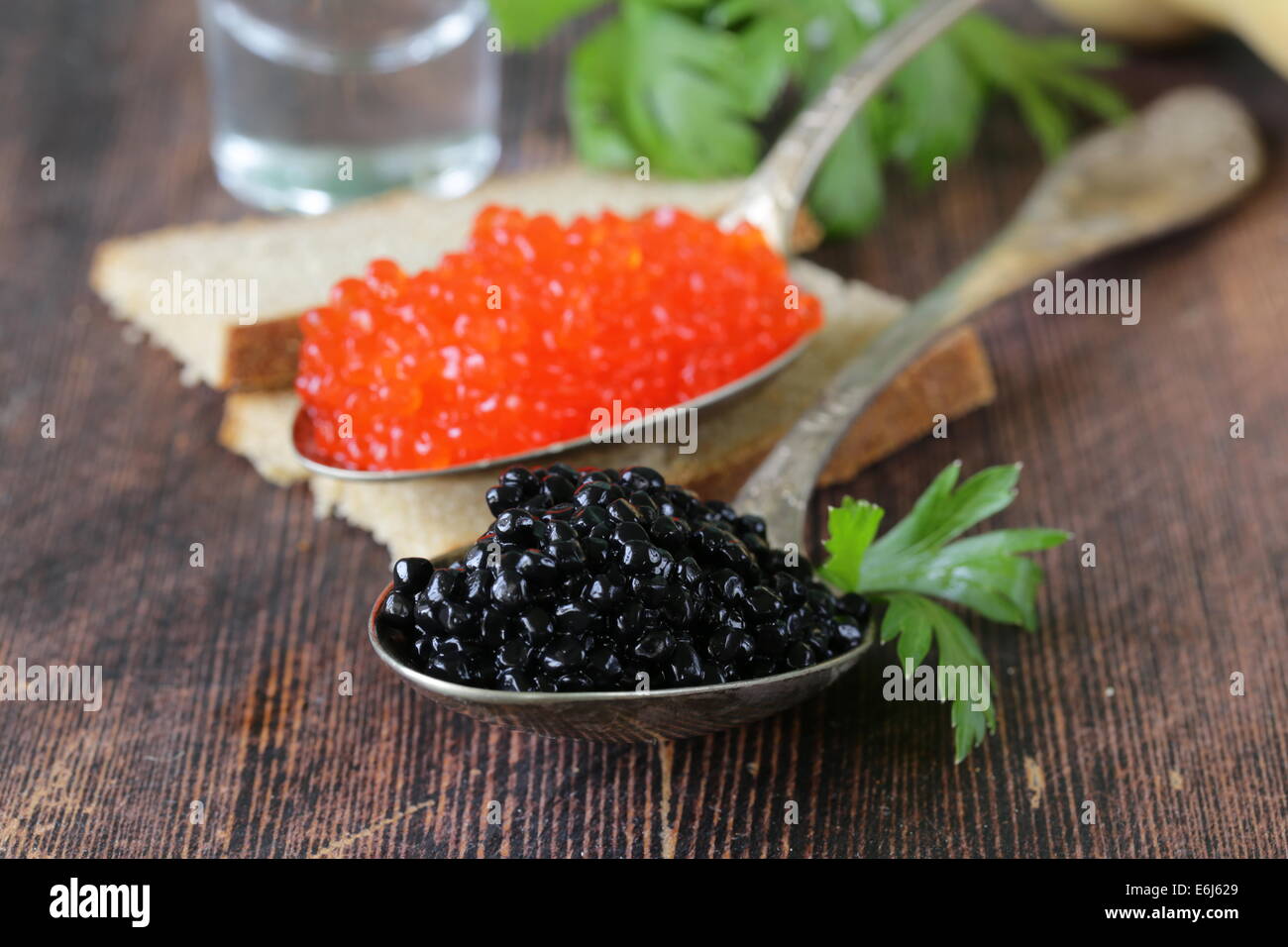 caviar with rye bread and two shots vodka on a wooden table Stock Photo