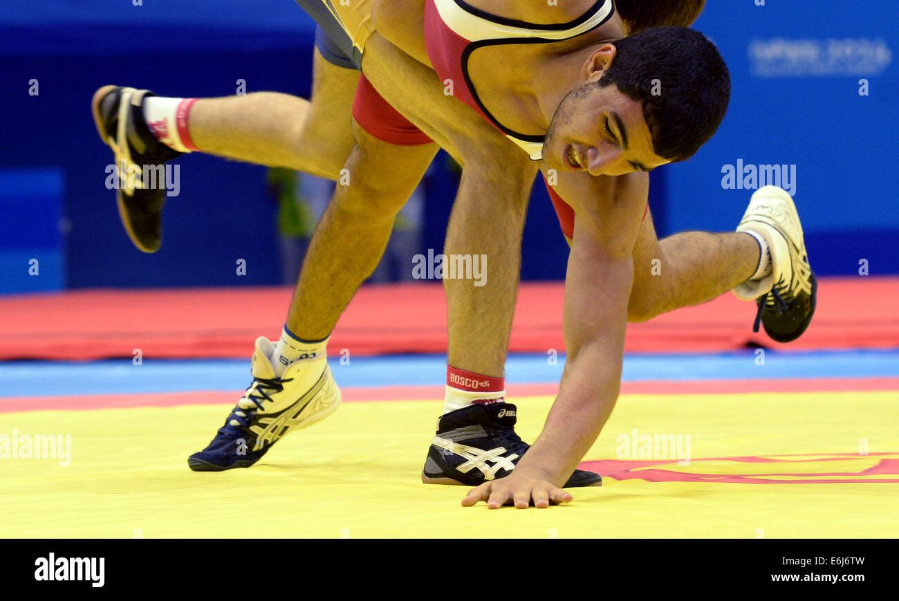 Nanjing, China's Jiangsu Province. 25th Aug, 2014. Silver medalist Zaven Mikaelyan of Armenia competes in the Men's Greco-Roman 58kg of Wrestling event of Nanjing 2014 Youth Olympic Games in Nanjing, capital of east China's Jiangsu Province, on Aug. 25, 2014. He lost the match. Credit:  Zhao Peng/Xinhua/Alamy Live News Stock Photo