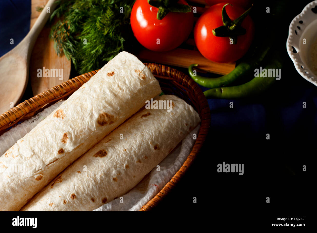 Traditional Turkish wrap (pita) bread on a dark table setting Stock