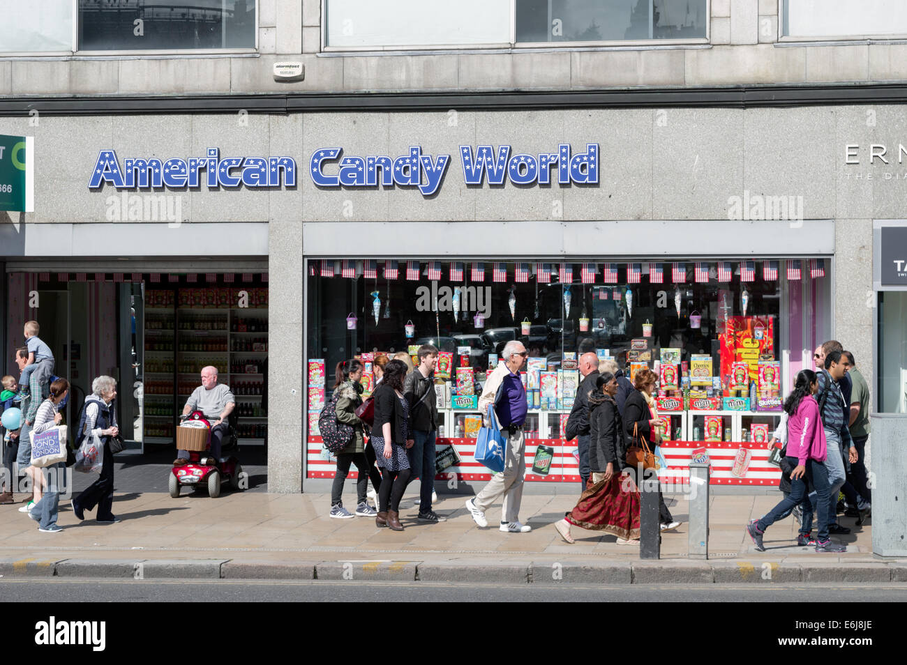 Shoppers walking in past American Candy World sweet store on Princes Street, Edinburgh Stock Photo
