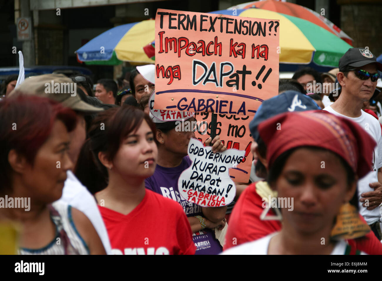 Manila, Philippines. 25th Aug, 2014. A protester holds a poster against the alleged Term Extension of President Aquino III in Mendiola, Manila. The constitution only allows a six year term without the possibility of reelection. Dubbed as the People's Initiative, protesters flocked to the Quirino Grandstand to sign a petition that stops any Charter Change that could extend the term of the president. They are also calling for the abolishment of the Pork Barrel of politicians. Credit:  J Gerard Seguia/Pacific Press/Alamy Live News Stock Photo