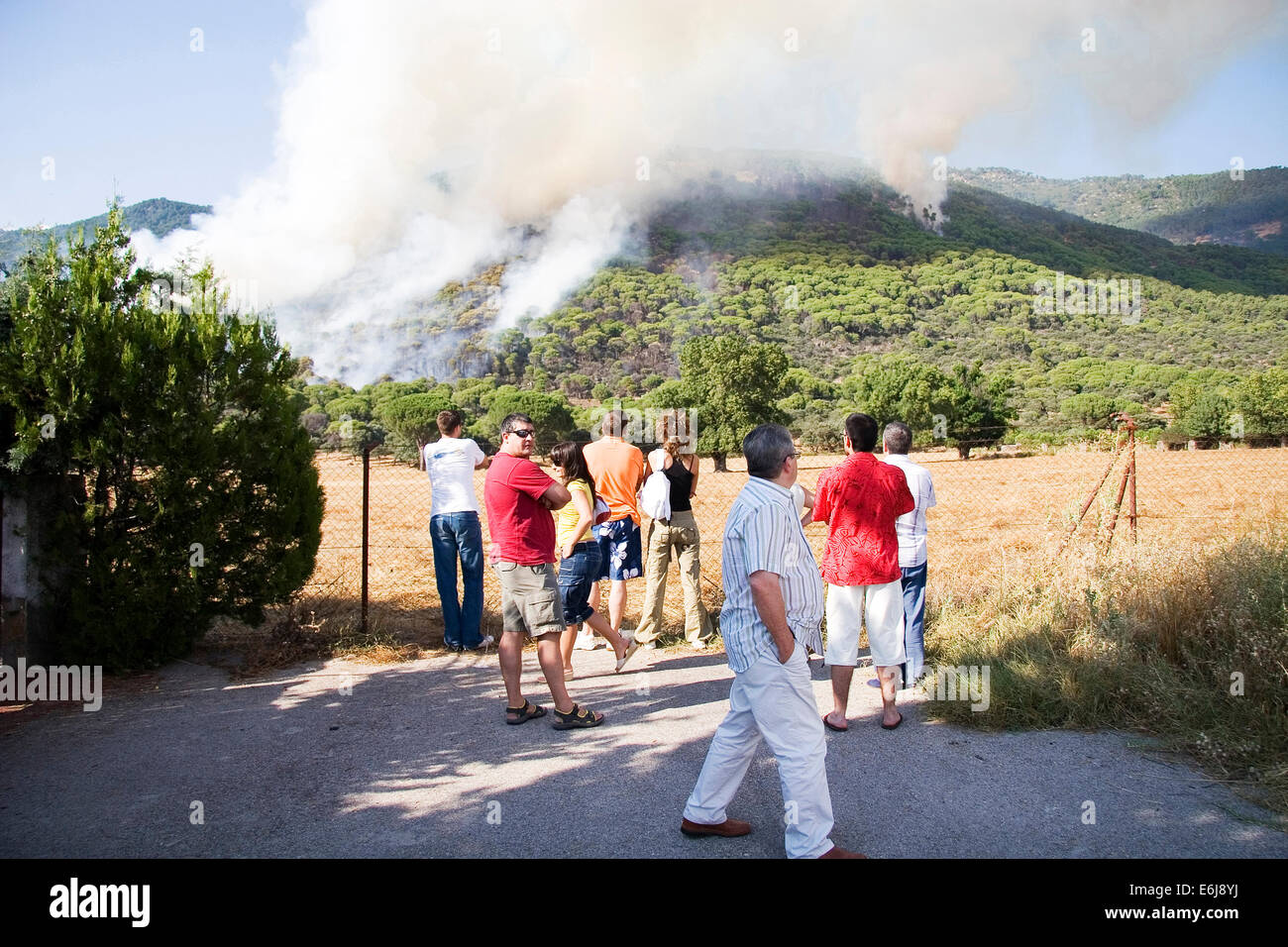 Group of people watching out a fire forest in Gredos mountain Stock Photo