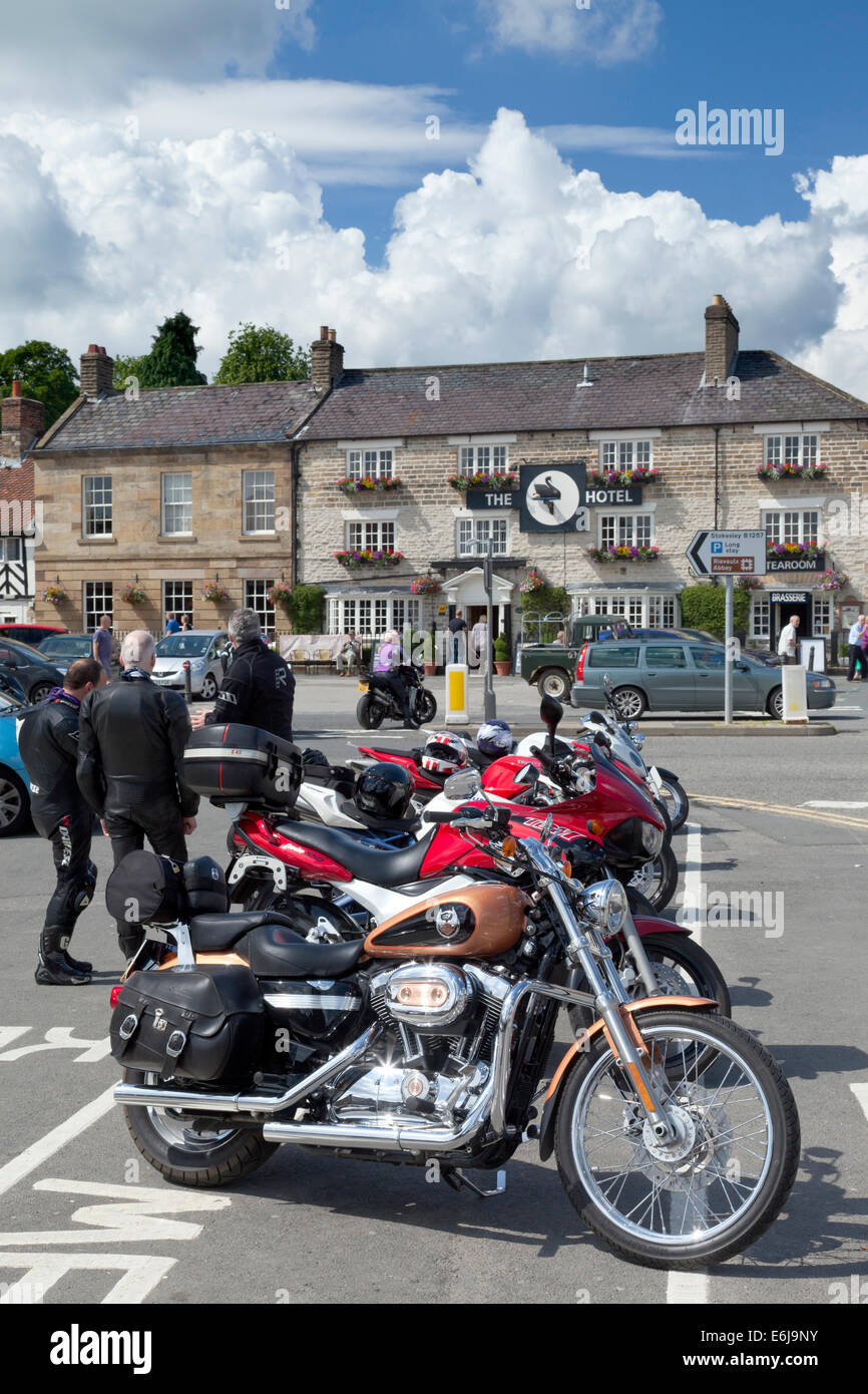 Motorbikes parked in the village square at Helmsley in North Yorkshire England Stock Photo
