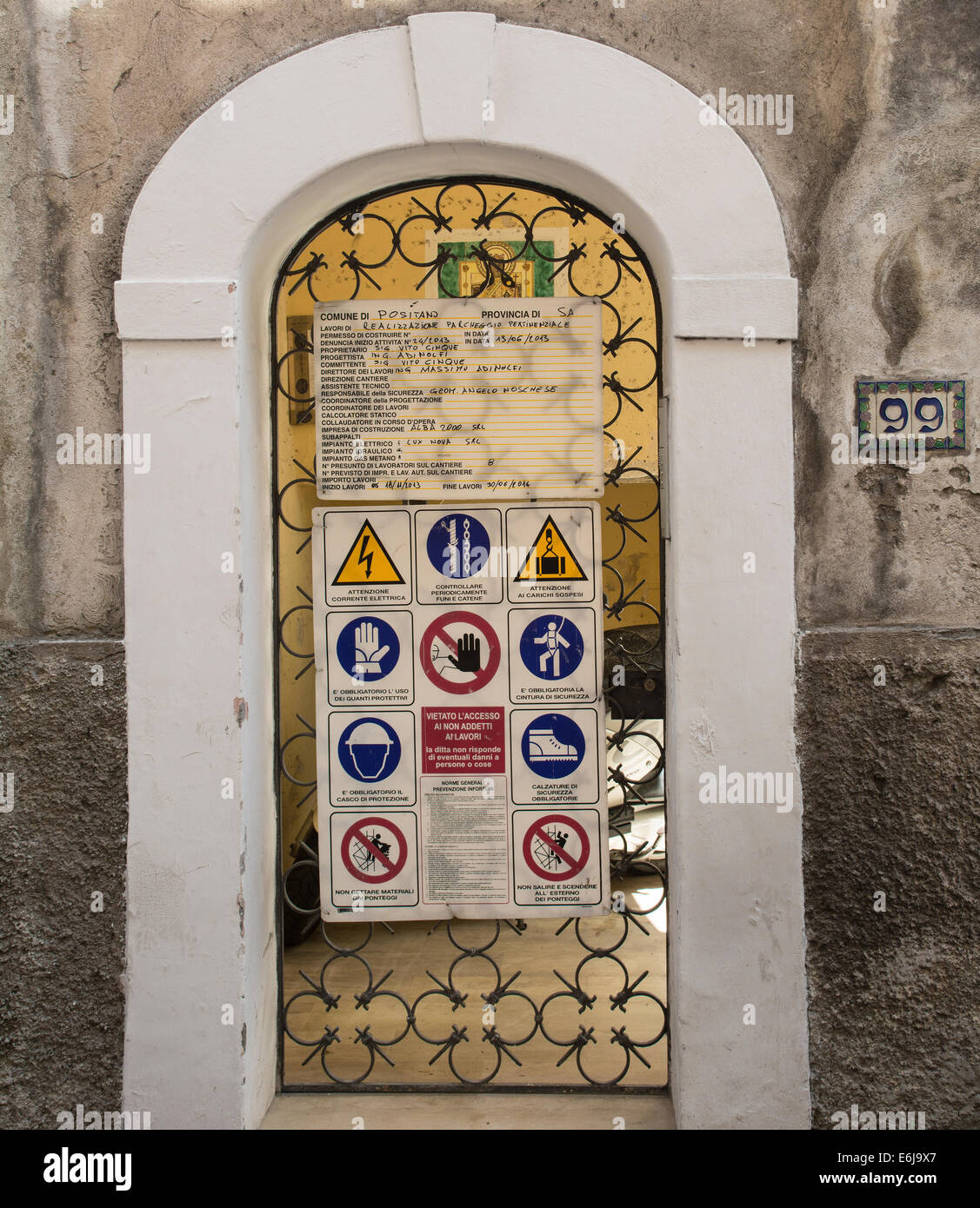 Entrance to a construction site in Italy, with health and safety signs in Italian. Stock Photo