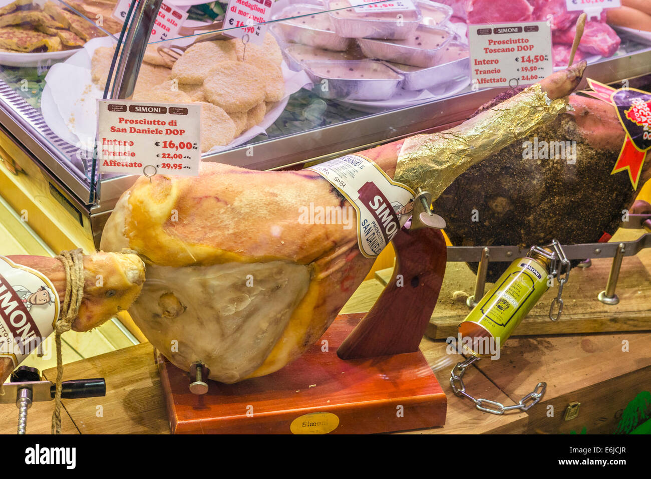 Whole San Daniele ham in a city centre shop, Bologna, Emilia Romagna, Italy Stock Photo