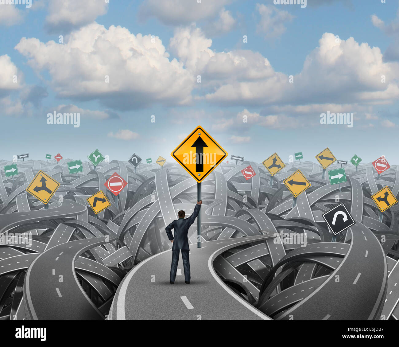 Success direction with a confident businessman standing on a group of tangled streets holding up a traffic sign with an upward arrow as a symbol for clear belief and conviction to a path of prosperity overcoming confusion and fear. Stock Photo