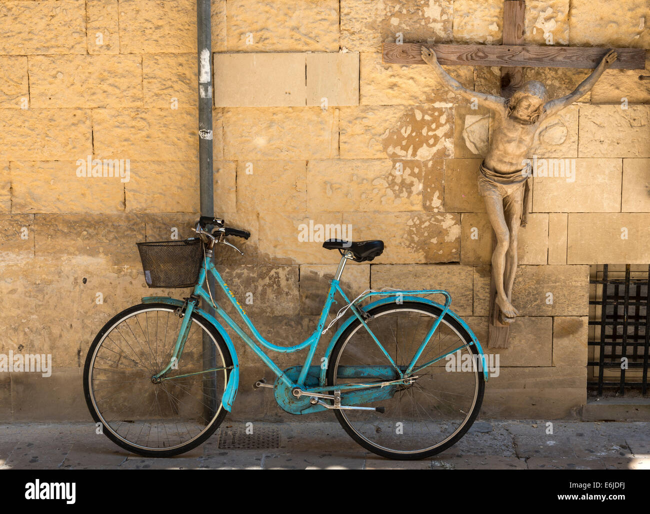 Bicycle and crucifix in the Via G. Libertini, Lecce, Puglia, Italy Stock Photo