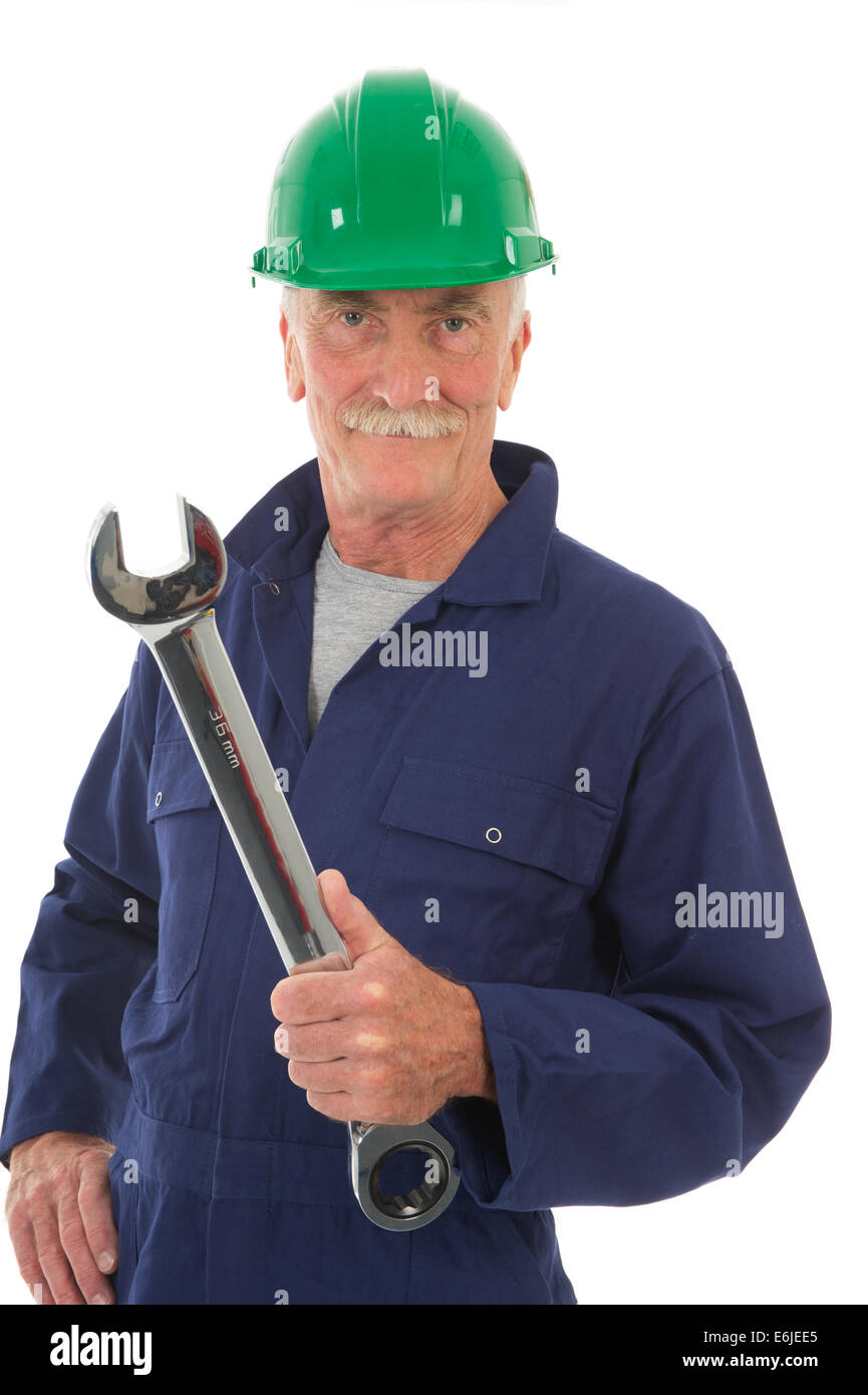 senior worker in blue overall with wrench isolated over white background Stock Photo