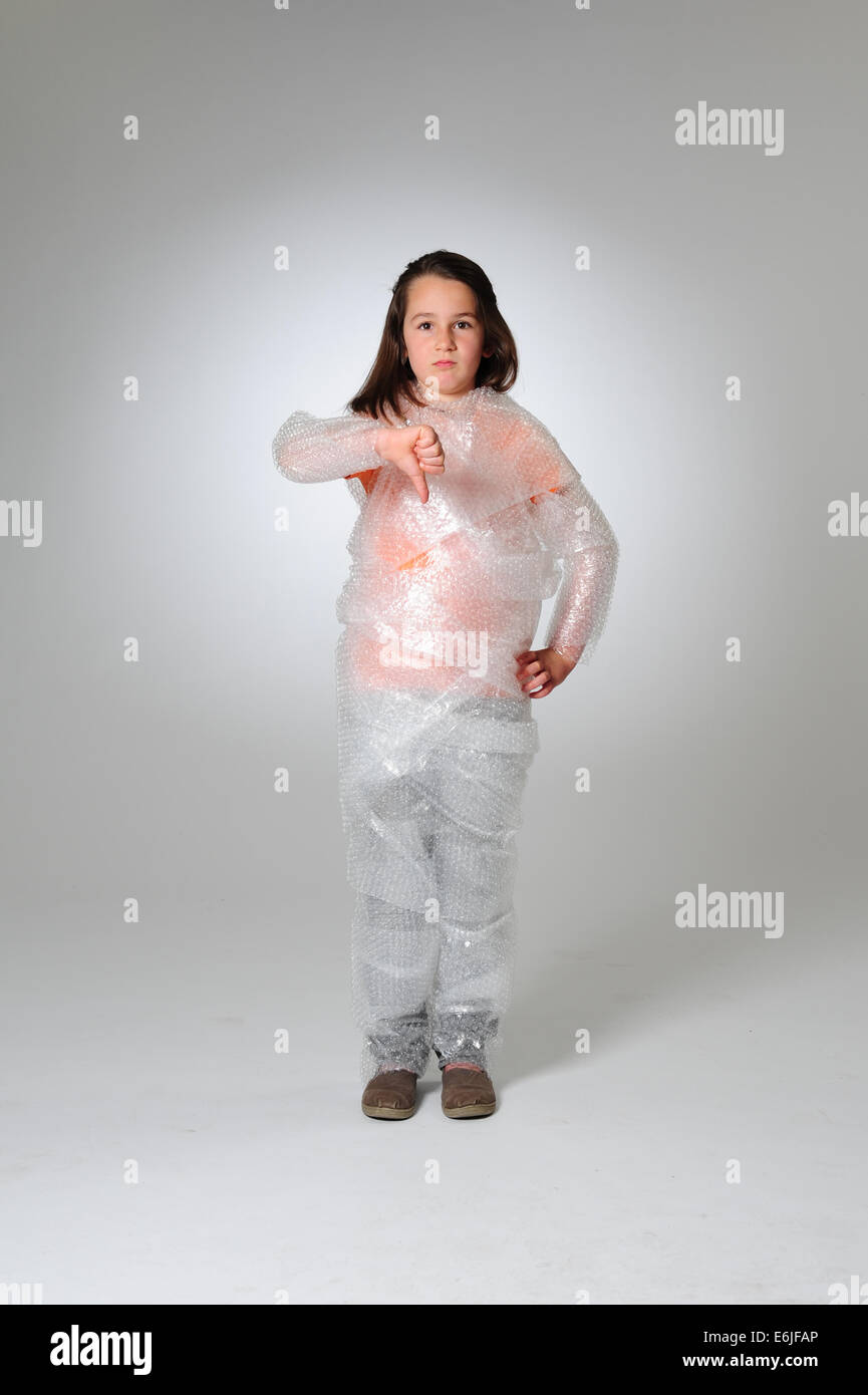 EDITORIAL ONLY - Over protection parenting helicopter parents kid wrapped in bubble wrap to protect from hurt or injury Stock Photo