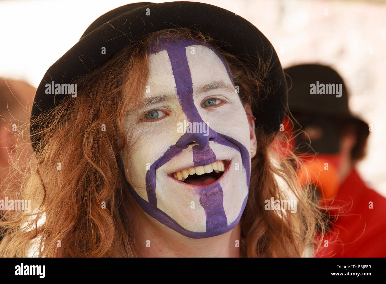 Smiling, long haired, teenage boy - face painted with CND symbol. Stock Photo