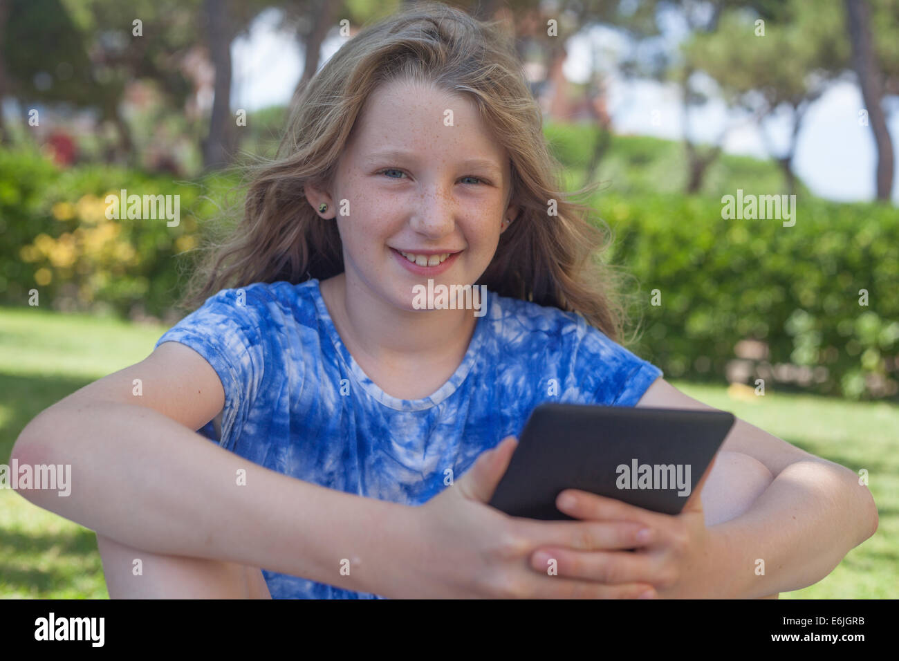 10 year old girl reading ebook smiling Stock Photo Alamy