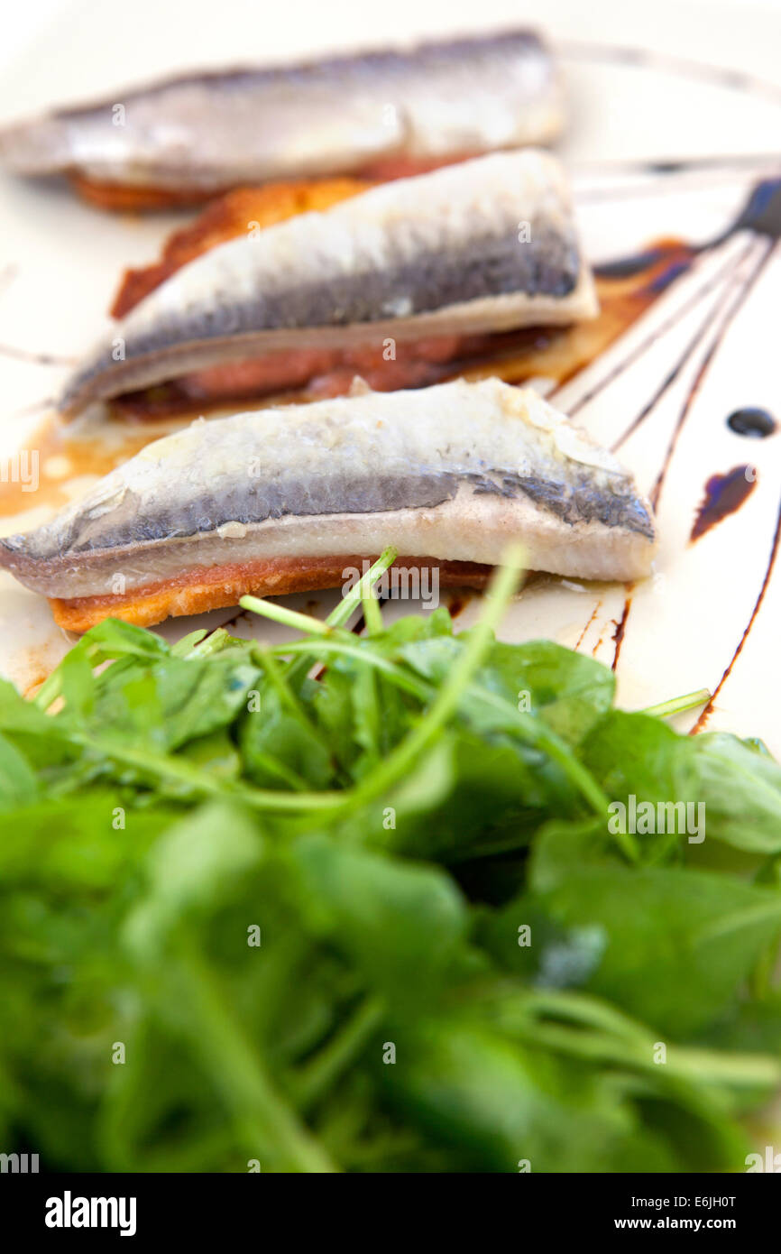 Sardines on toast appetizer at restaurant in Lisbon, Portugal Stock