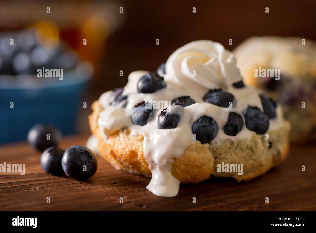A delicious homemade blueberry shortcake on scones with cream and whipped cream. Stock Photo