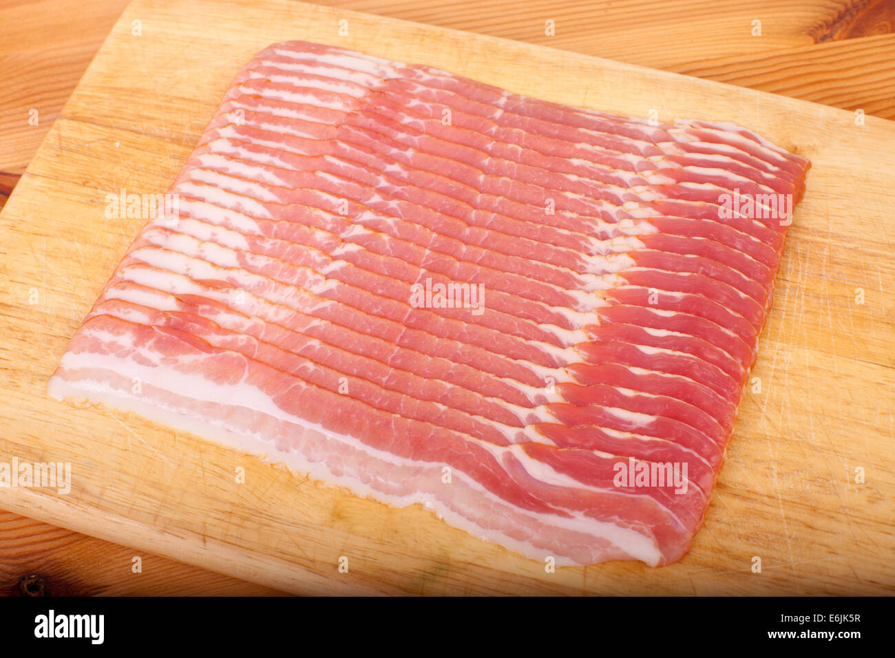 streaky bacon on the wooden chopping board Stock Photo