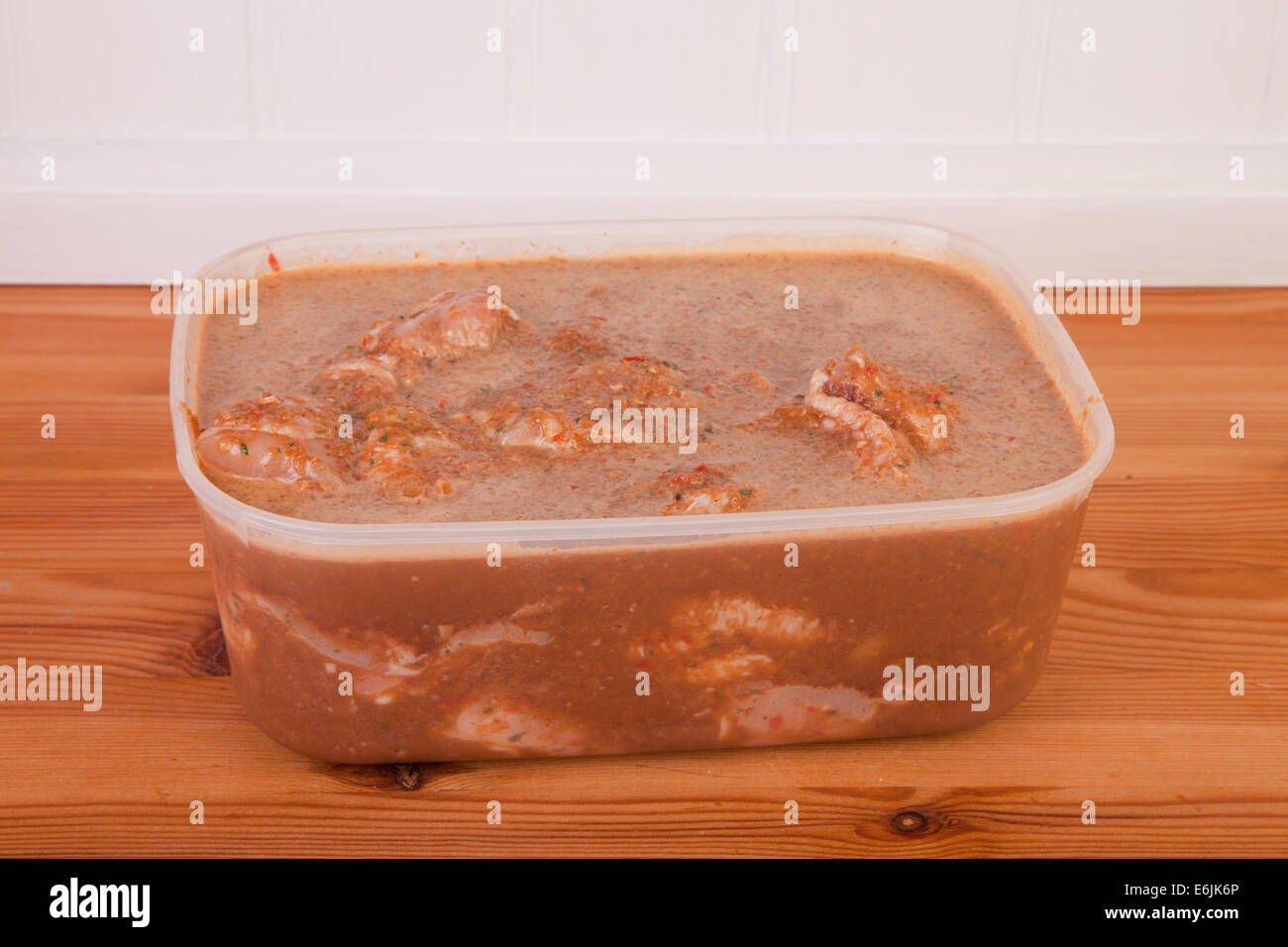 jerk chicken in marinade on the wooden table Stock Photo