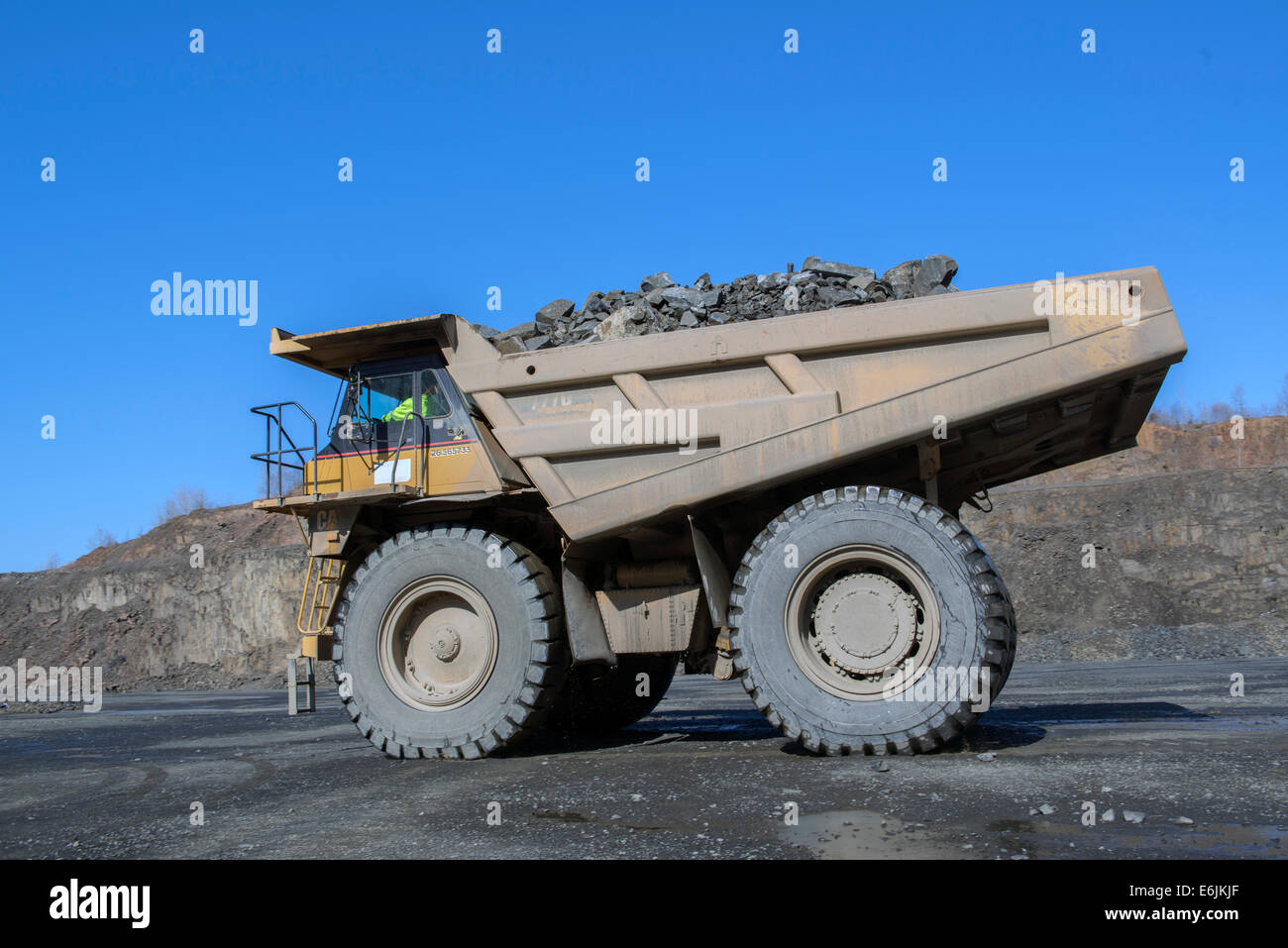 Branford, CT.  100 ton Caterpillar 7770D truck hauling basalt trap rock mined from basalt ridge at the Tilcon plant. Stock Photo