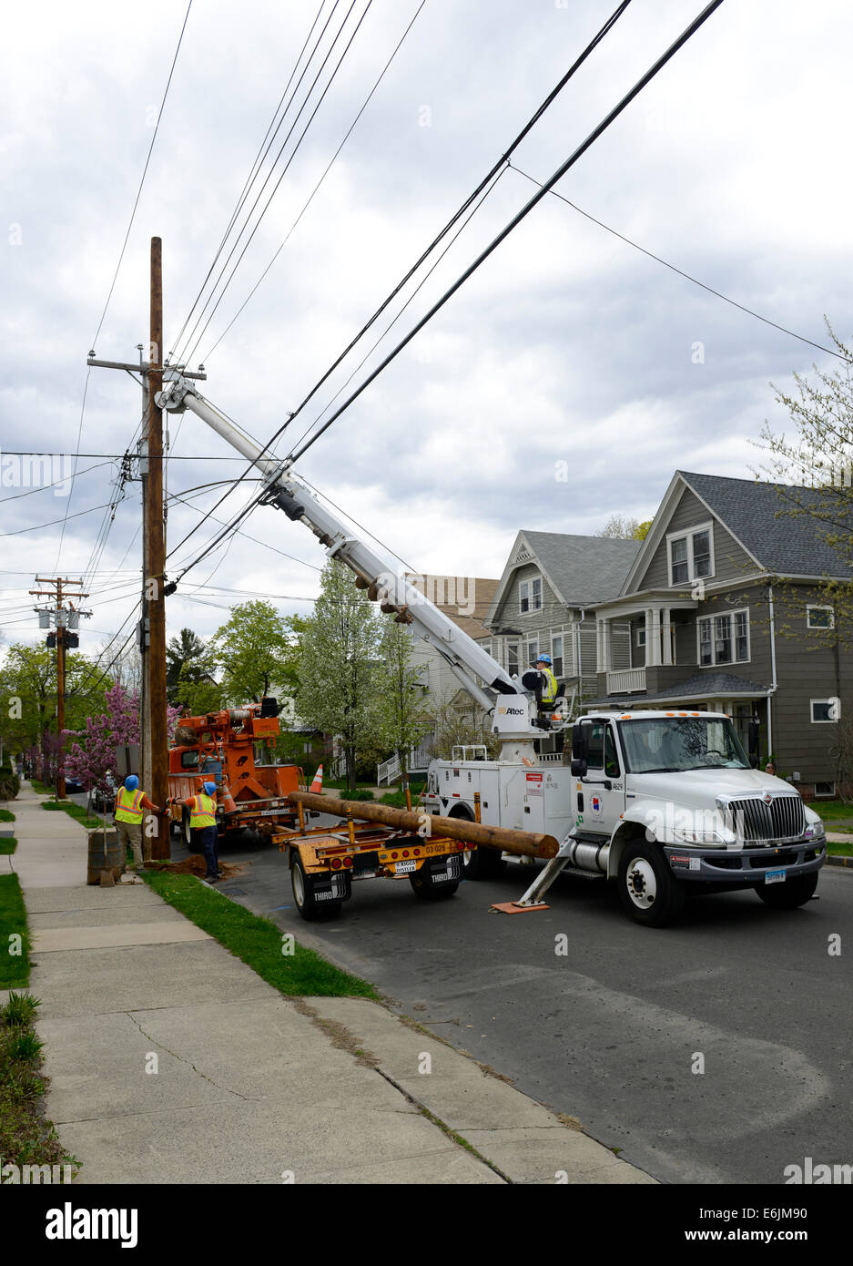 Altec Derrick Digger machine putting up new telephone poles in New Haven, CT. Stock Photo