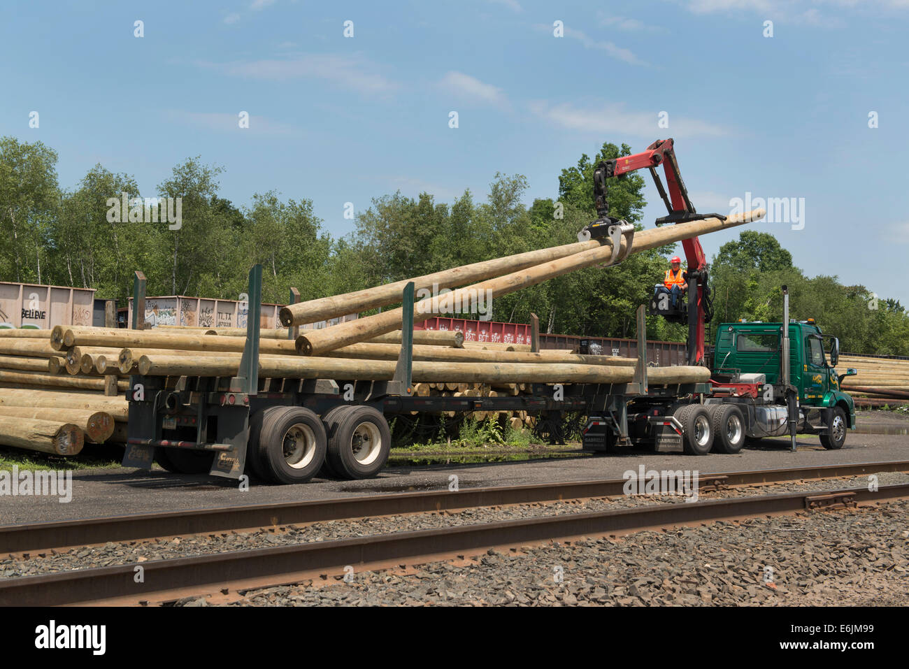 Flat, or open bed truck fitted with knuckle boom for moving telephone poles. Stock Photo