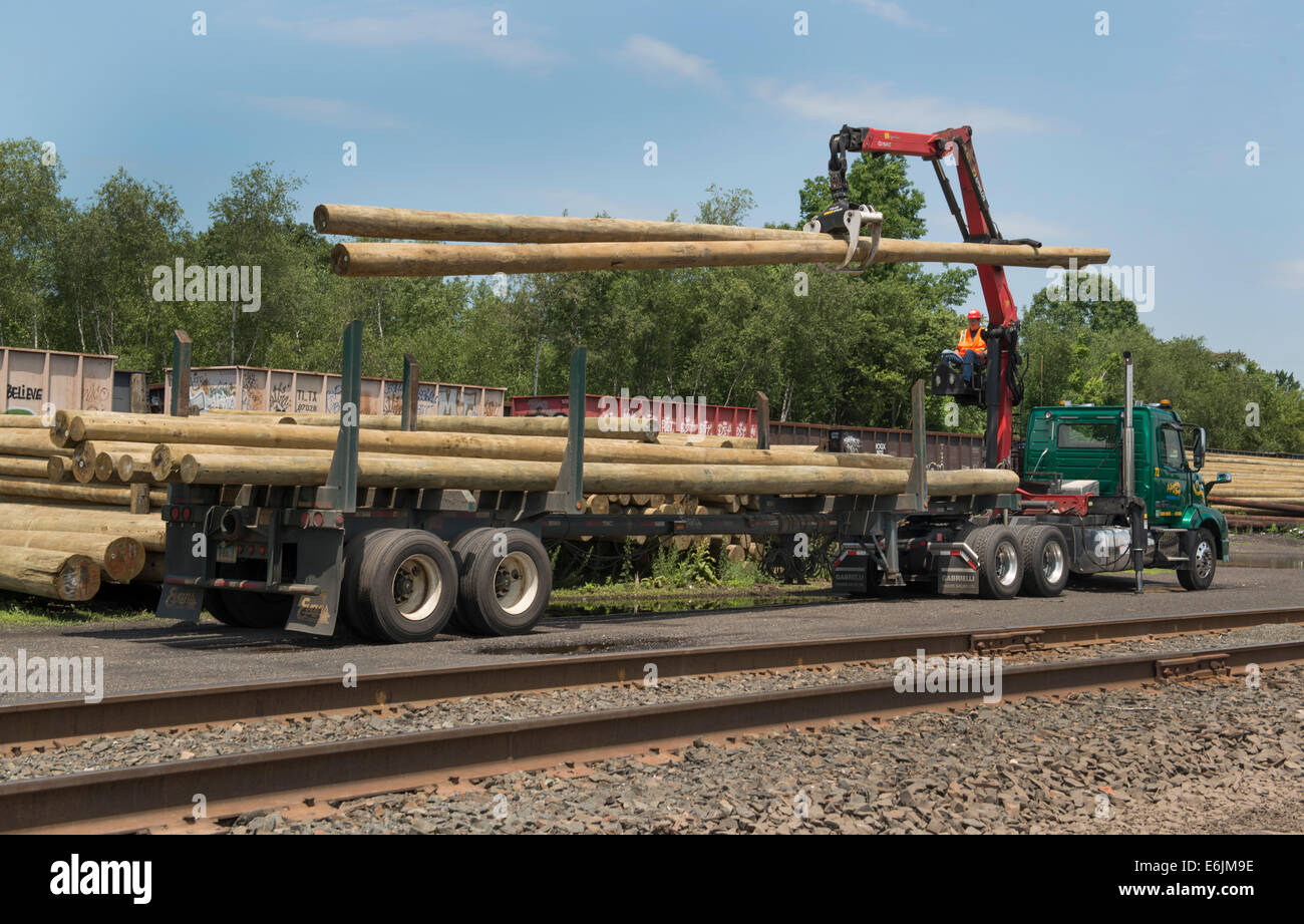 Flat, or open bed truck fitted with knuckle boom for moving telephone poles. Stock Photo