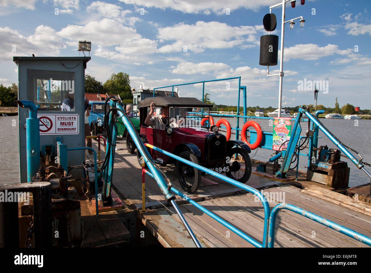 Old Austin drives off the Reedham Ferry on the River Yare in Norfolk. Stock Photo