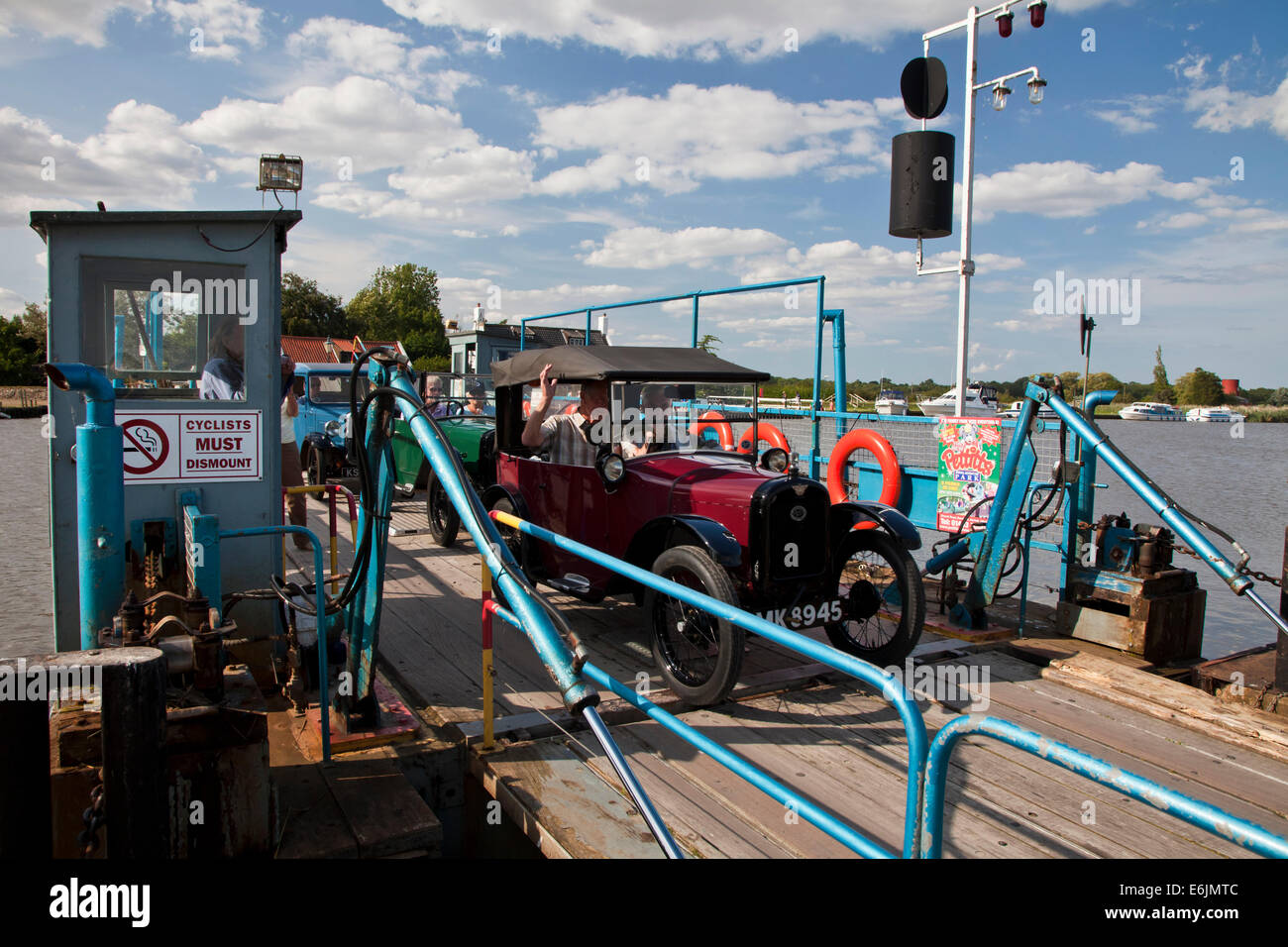 Old Austin drives off the Reedham Ferry on the River Yare in Norfolk. Stock Photo