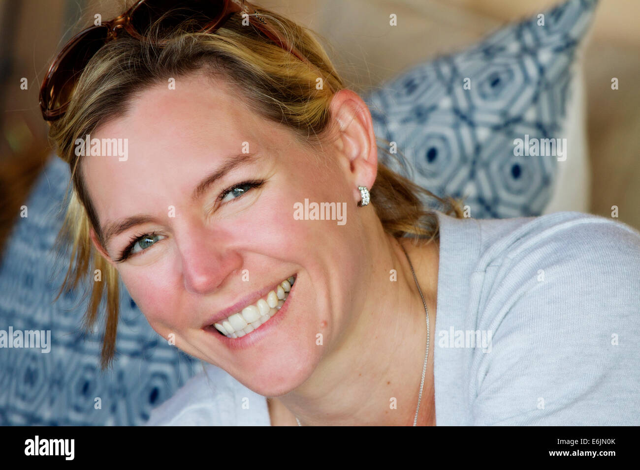 Smiling blond lady in her late thirties Stock Photo