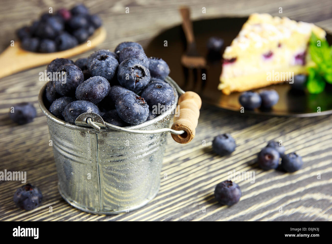Blueberry cake and fresh fruits arranged on a wooden table Stock Photo