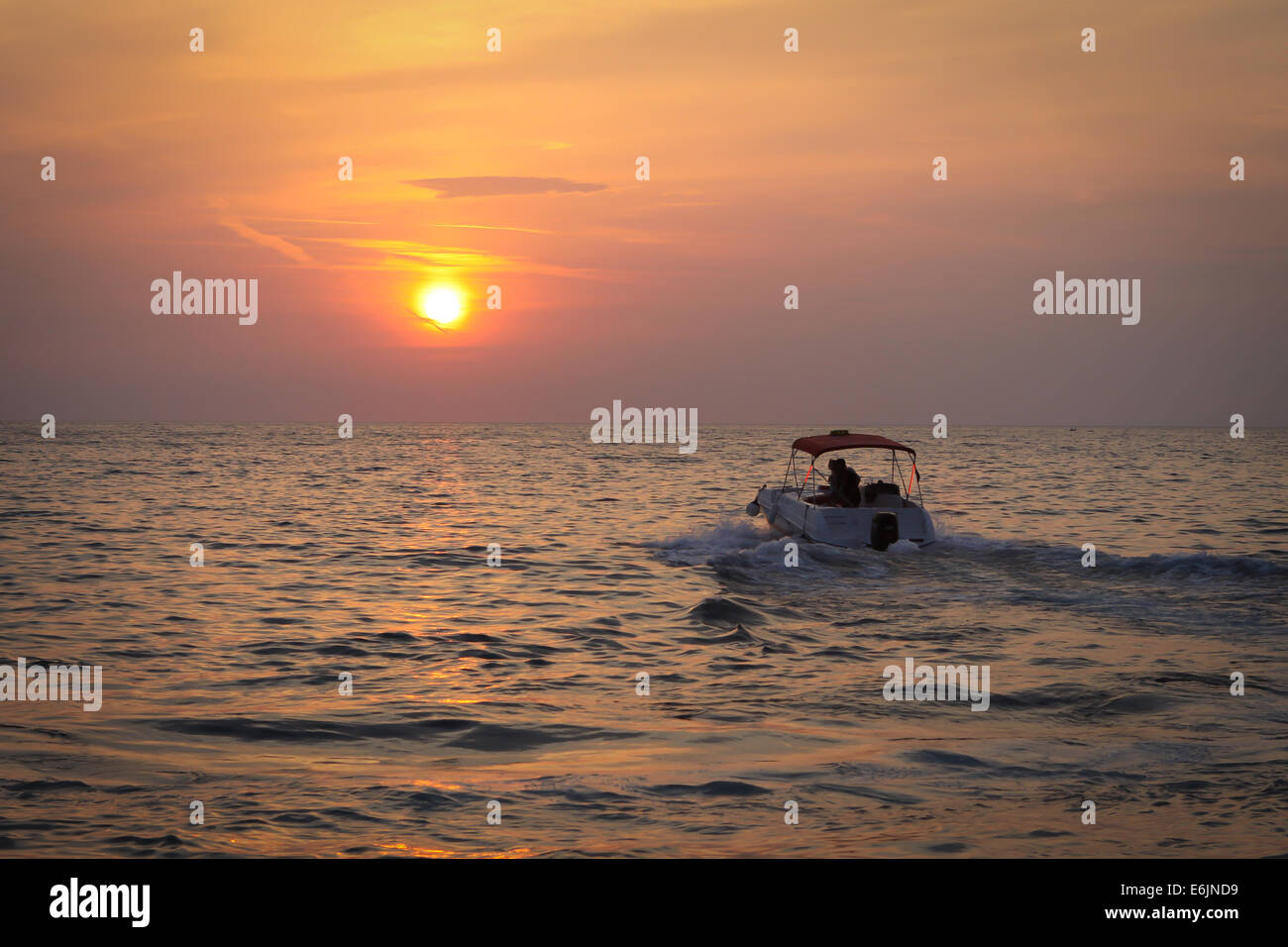 Silhouette boat in the sea at sunset Stock Photo - Alamy