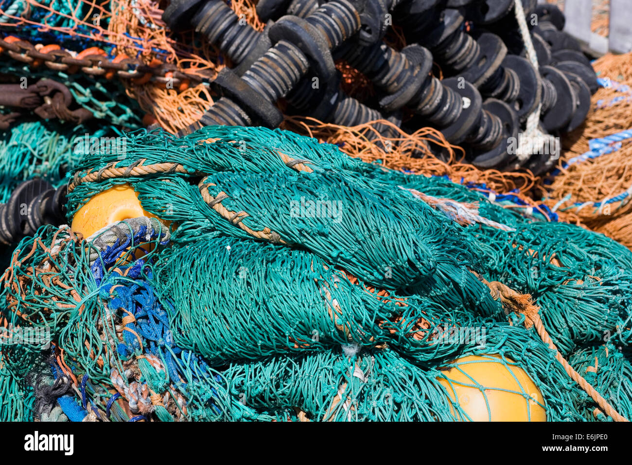 Fishing nets and floats along the quayside. Stock Photo