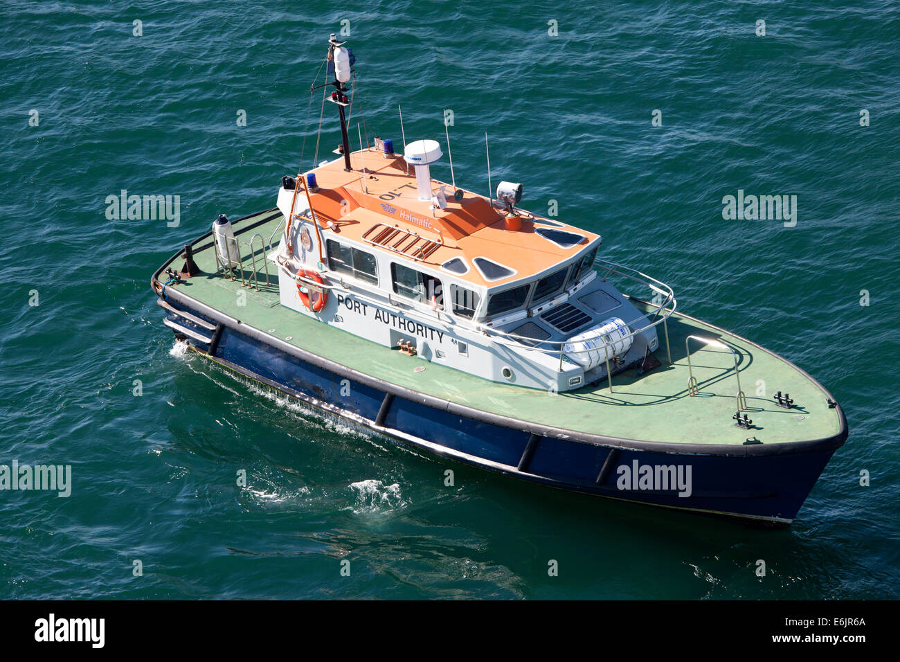 Pilot boat transporting the pilots between land and the outbound cruise ship Stock Photo